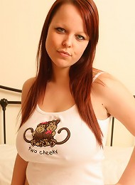 Cheeky redhead strips to show off her jugs
